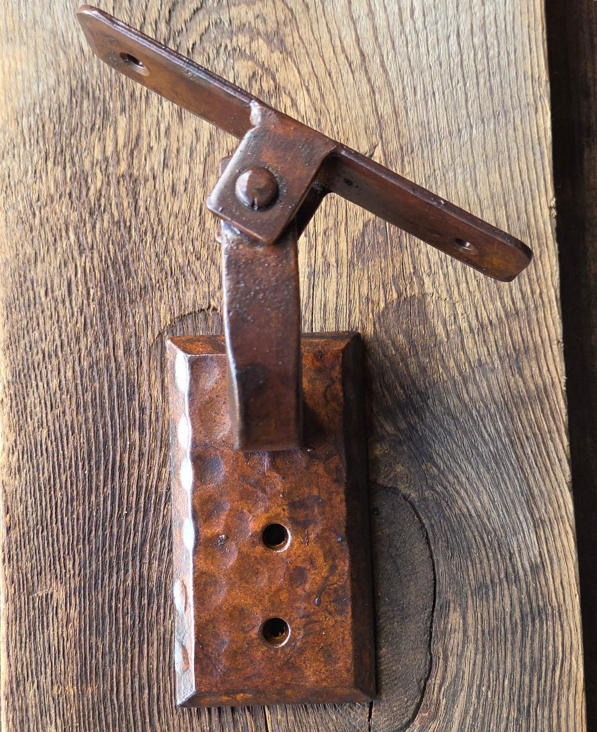 Rustic metal bracket on a wooden surface